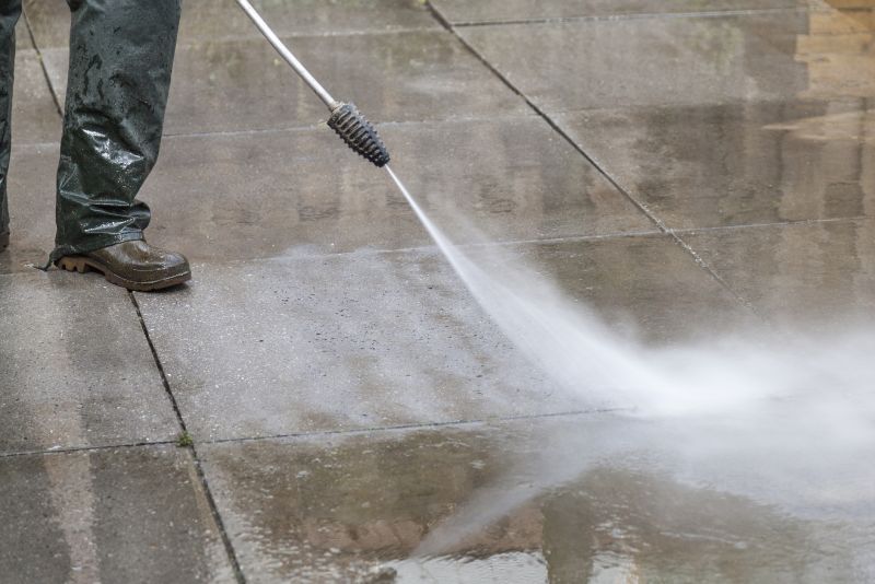 Powerwashing a sidewalk
